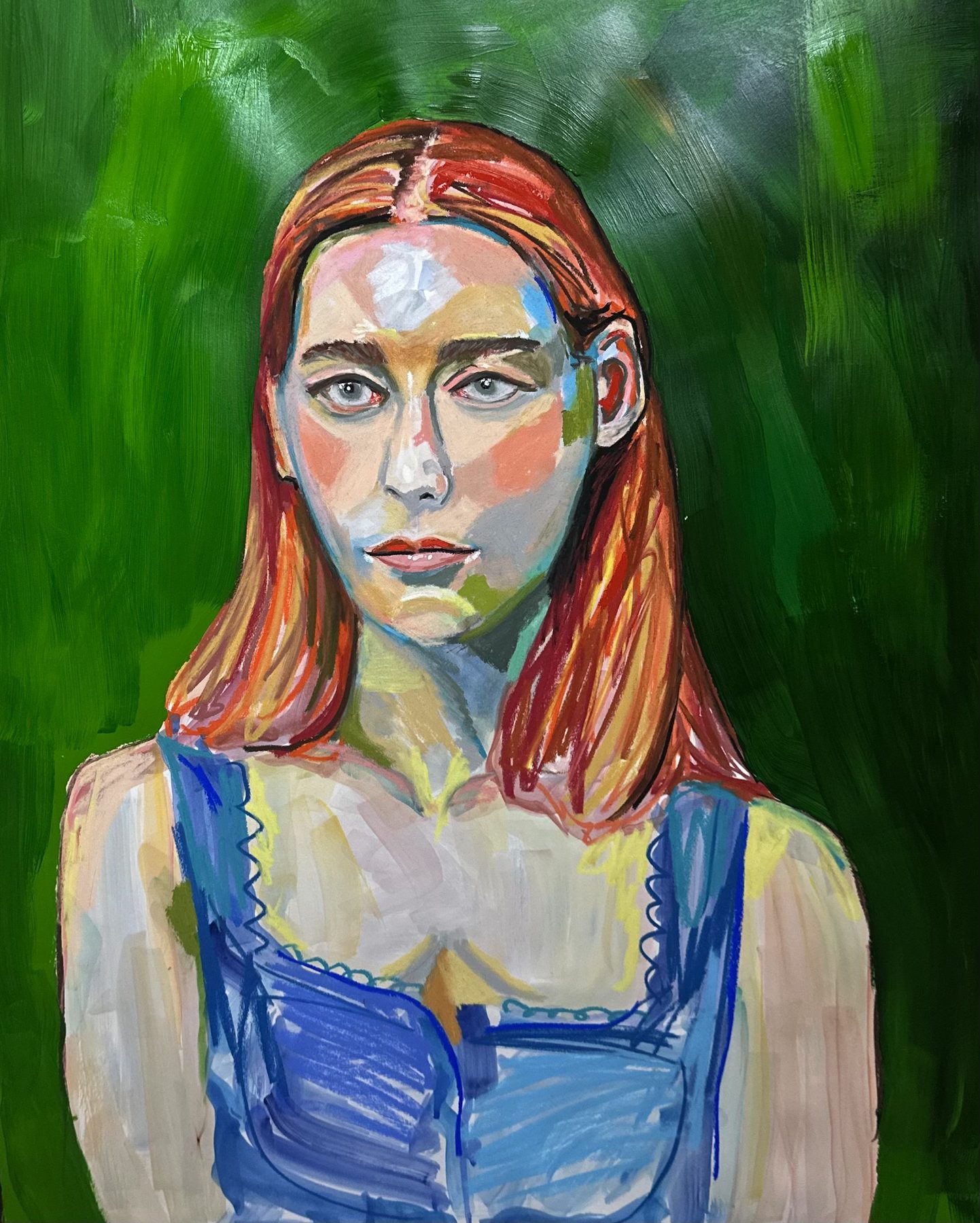 Private portrait of a young woman with red hair in a blue dress, green background